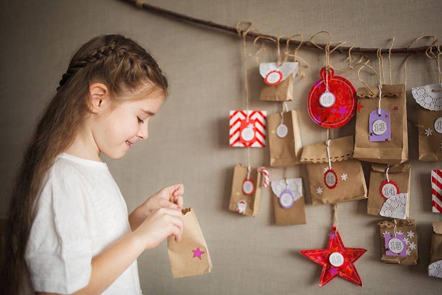 advent calendar hanging on the wall. child opens present. Christmas kids fun. diy.